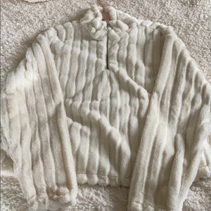 A off white slight cropped fuzzy quarter zip.
